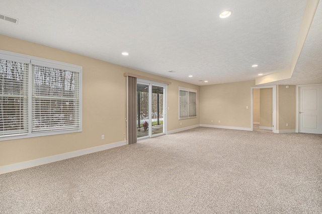 empty room featuring recessed lighting, visible vents, light carpet, and baseboards