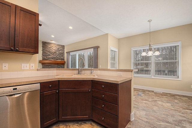 kitchen featuring a peninsula, a sink, light countertops, stainless steel dishwasher, and dark brown cabinets