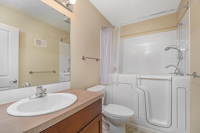 bathroom featuring visible vents, toilet, curtained shower, a textured ceiling, and vanity