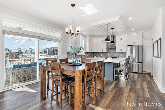 dining space with dark wood-style floors, recessed lighting, baseboards, and an inviting chandelier