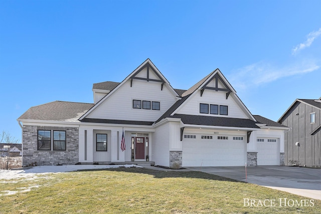 view of front of home featuring an attached garage, stone siding, concrete driveway, roof with shingles, and a front yard