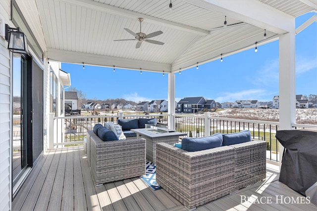 wooden deck with an outdoor living space with a fire pit, a residential view, and a ceiling fan