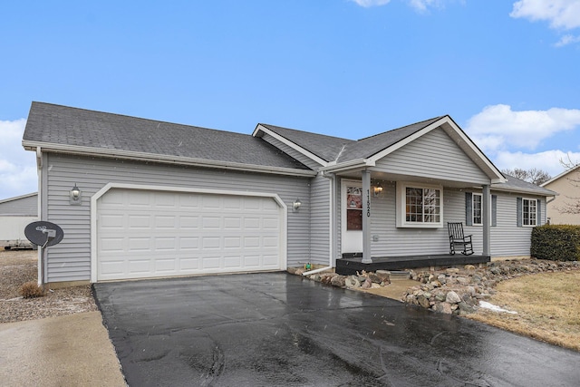 ranch-style home with driveway, a shingled roof, and an attached garage