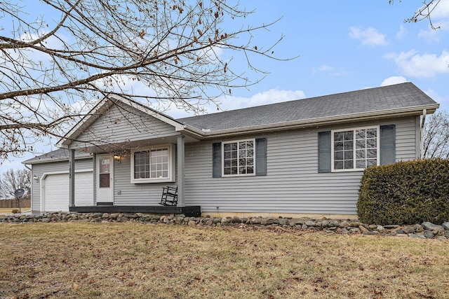 single story home with a front yard and an attached garage