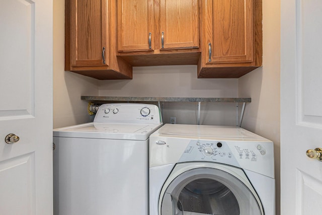 laundry area with cabinet space and washer and dryer