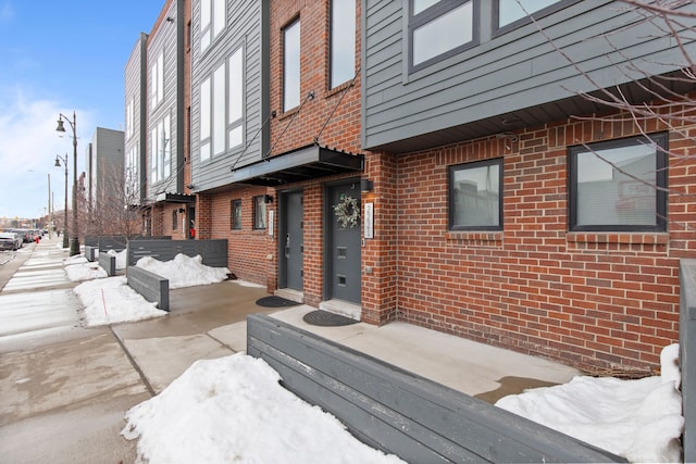 exterior space featuring brick siding