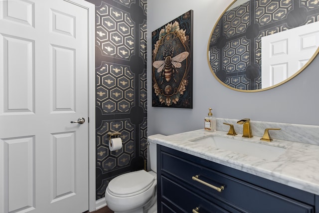 half bathroom with vanity and toilet