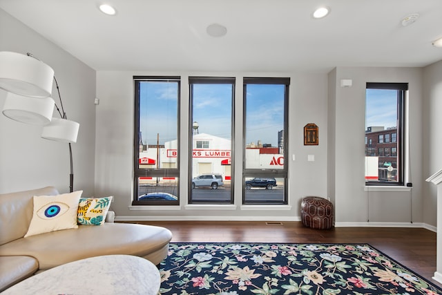 living area with recessed lighting, baseboards, and wood finished floors