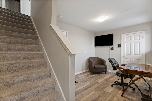 home office with light wood-type flooring and baseboards