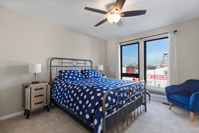 carpeted bedroom featuring a ceiling fan and baseboards