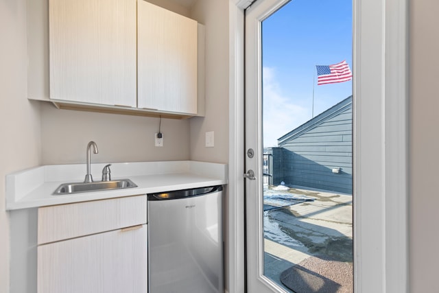 kitchen featuring dishwasher, light countertops, and a sink