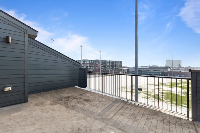 view of patio with a view of city and a balcony