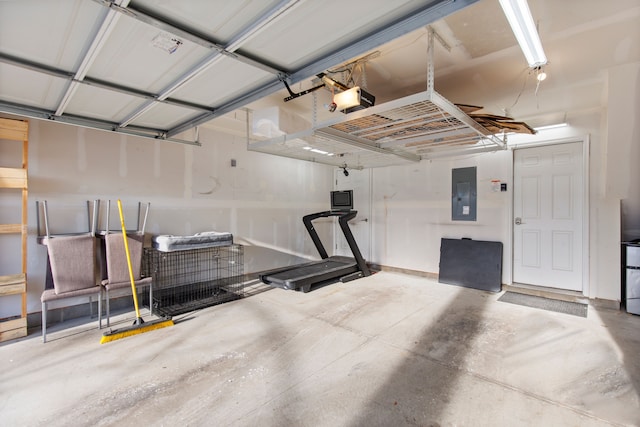 garage with electric panel and a garage door opener