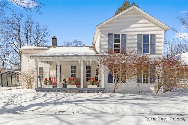 traditional-style house with covered porch and a chimney