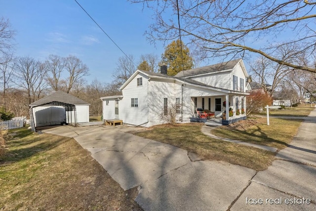 view of side of home with fence, a porch, a yard, a carport, and concrete driveway