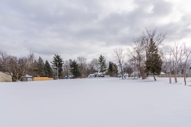 snowy yard with fence