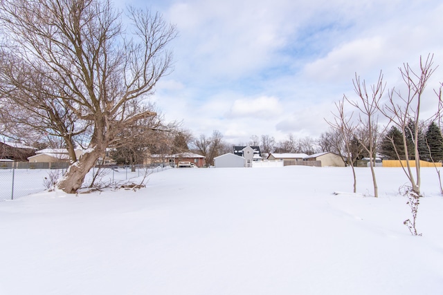 yard covered in snow with fence