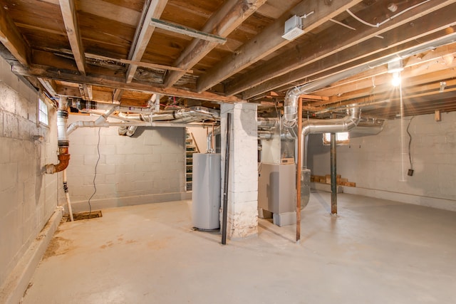 unfinished basement with gas water heater and heating unit