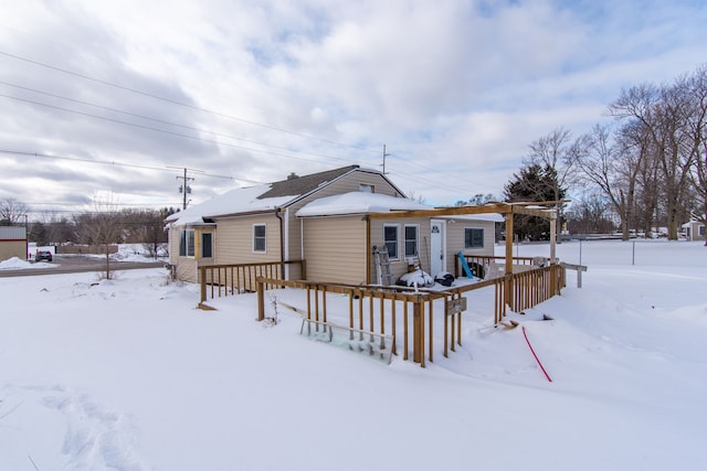 view of snow covered back of property