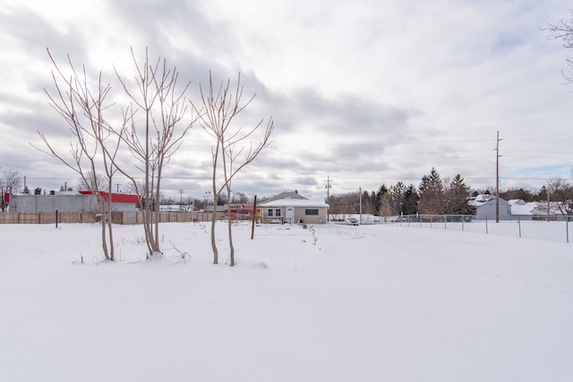 yard covered in snow with fence