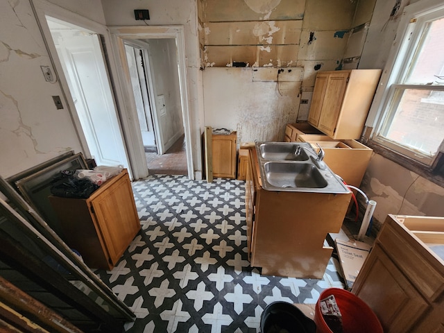 kitchen featuring a sink and tile patterned floors