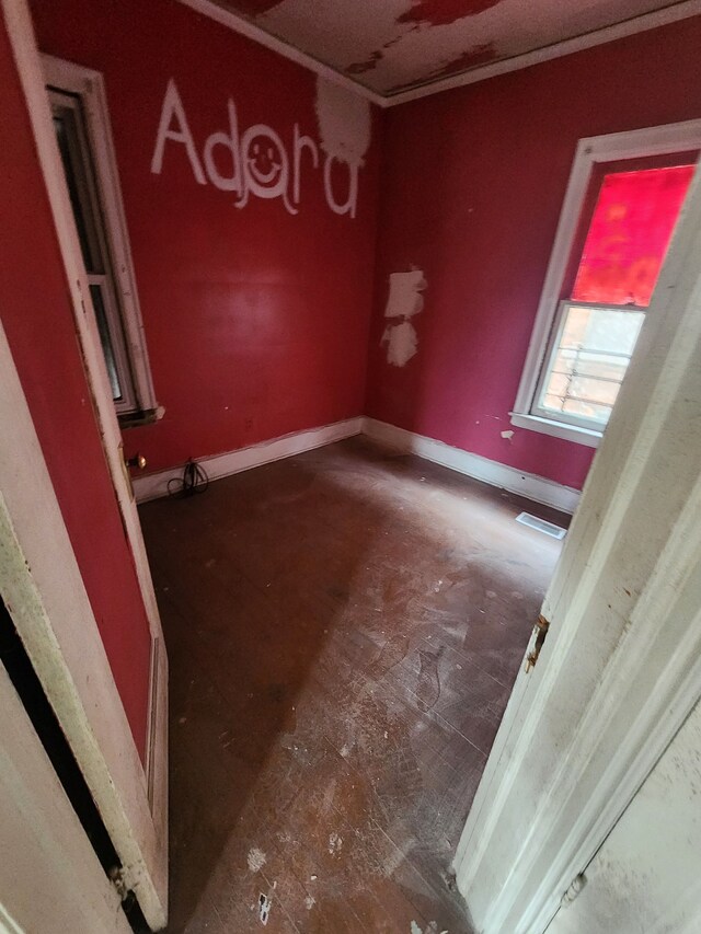 empty room featuring visible vents and baseboards