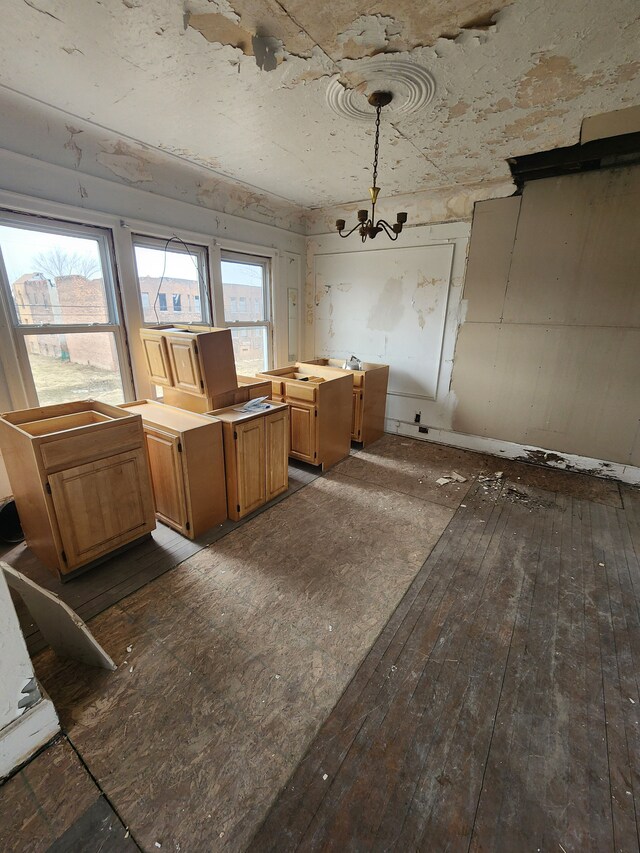 interior space with a notable chandelier and dark wood finished floors