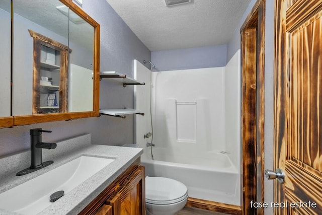 bathroom with shower / bathing tub combination, a textured ceiling, toilet, and vanity