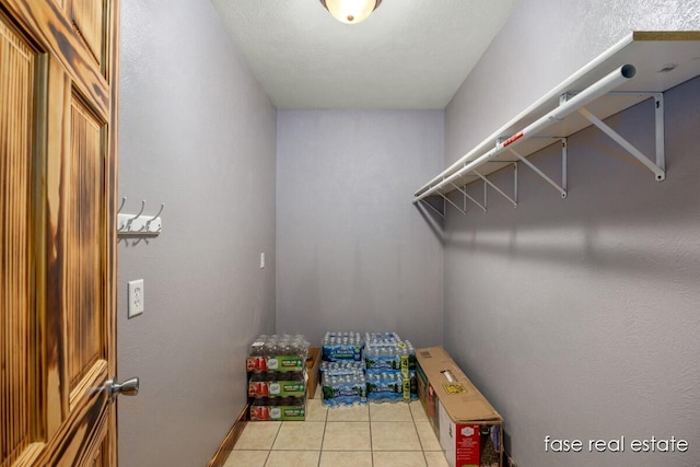 spacious closet featuring light tile patterned flooring