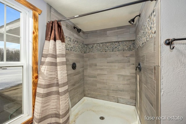 full bath with a tile shower