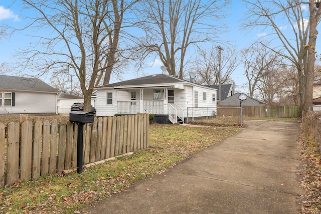 bungalow with a fenced front yard and a porch