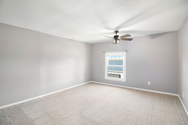 spare room with ceiling fan, baseboards, and carpet flooring