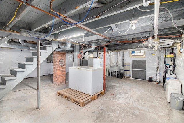 basement featuring stairs and a sink