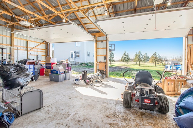 garage featuring a garage door opener and metal wall