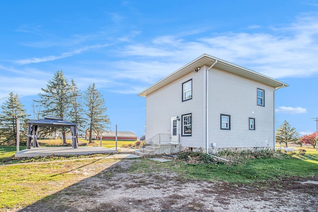 view of property exterior with a gazebo