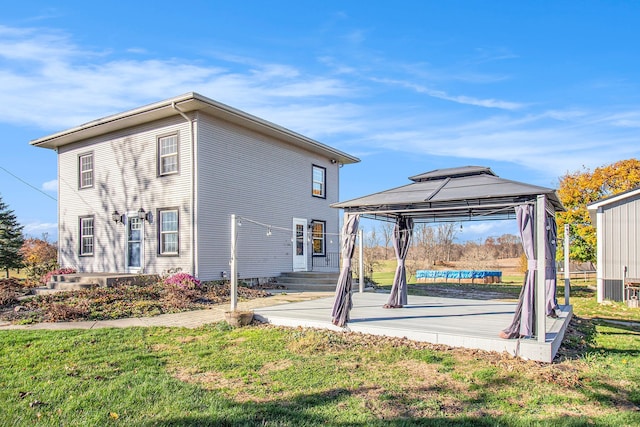 view of side of property with a yard and a gazebo