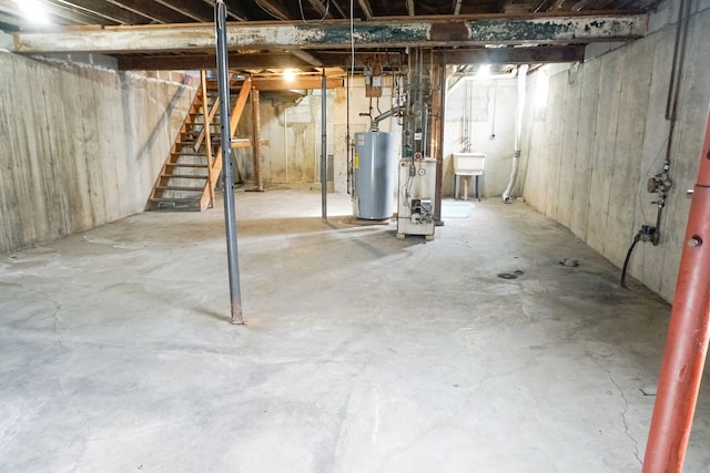 unfinished basement with water heater and stairs