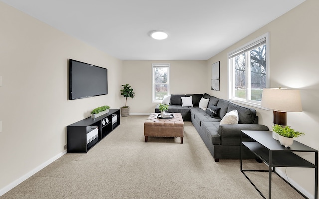 carpeted living area with baseboards