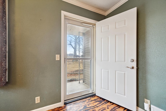 doorway to outside with visible vents, baseboards, crown molding, and a textured wall