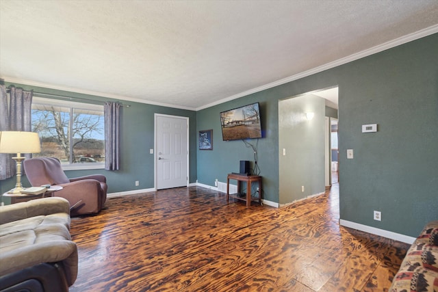 living area with a textured ceiling, baseboards, wood finished floors, and ornamental molding