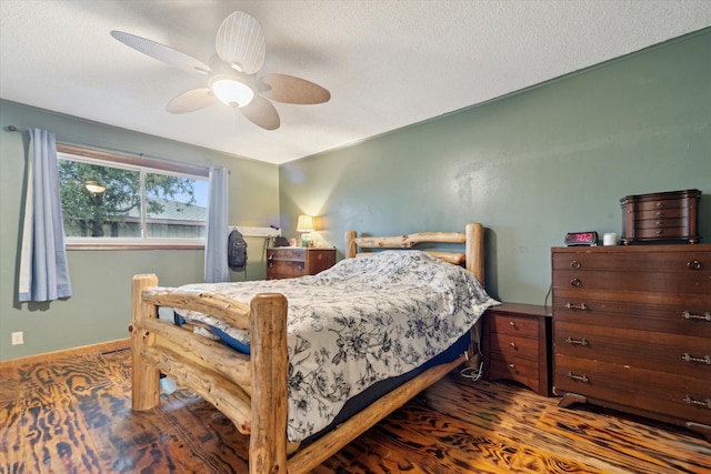 bedroom with a textured ceiling, ceiling fan, wood finished floors, and baseboards