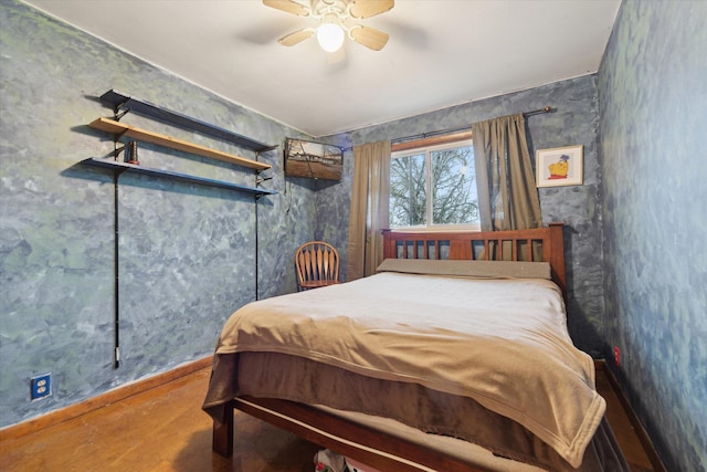 bedroom featuring a ceiling fan and baseboards