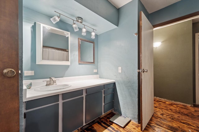 full bathroom with vanity and wood finished floors