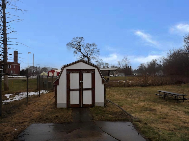 view of shed featuring fence