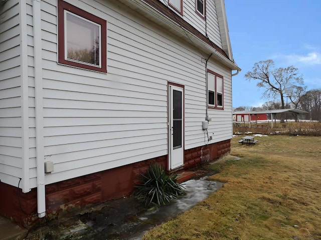 view of side of home with a yard