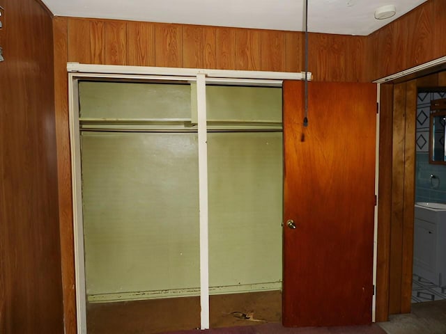 unfurnished bedroom featuring wood walls