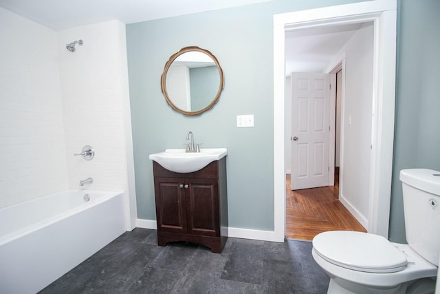 bathroom featuring toilet, baseboards, shower / bathing tub combination, and vanity