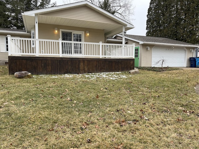 view of front of home featuring an attached garage, a porch, and a front yard