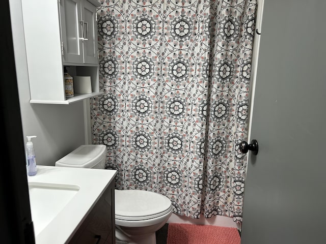 bathroom with vanity, toilet, and a shower with curtain