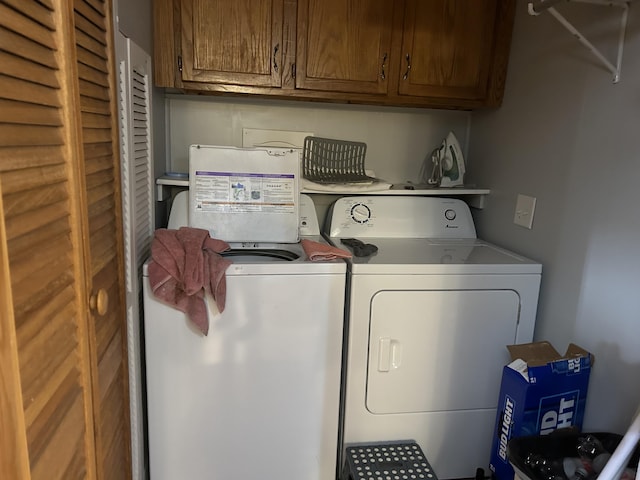 washroom with independent washer and dryer and cabinet space